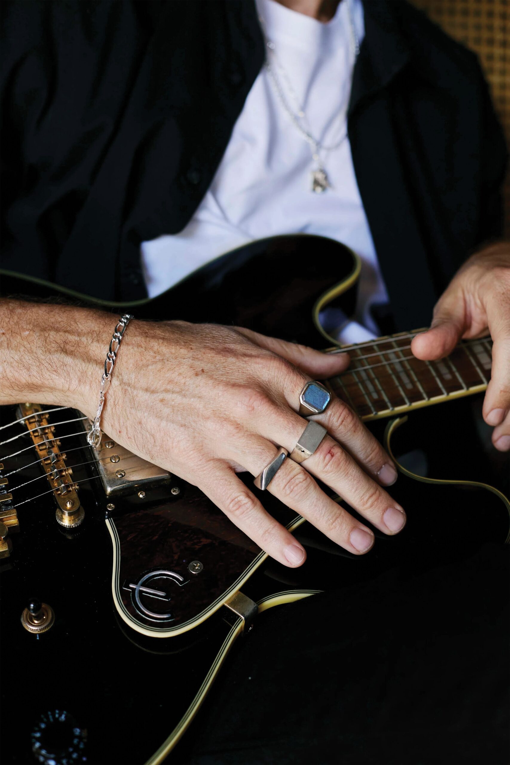 NECKLINE: Necklace & Hand on Guitar amid splendour of Victorian Silver Black Betty Range.