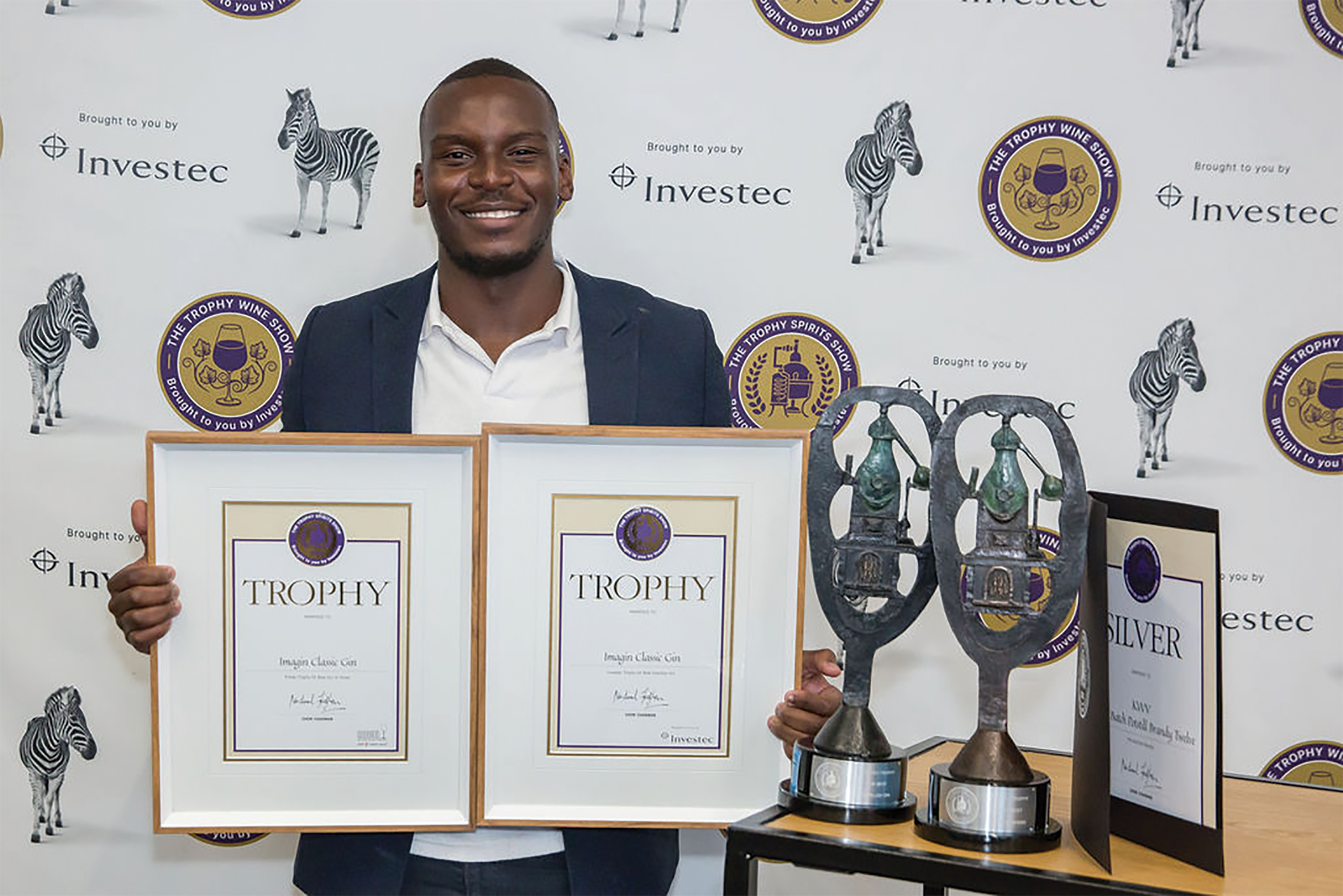 Njabulo Phewane from KWV with trophies for Best Distilled Gin and Best Gin of Show for Imagin Classic