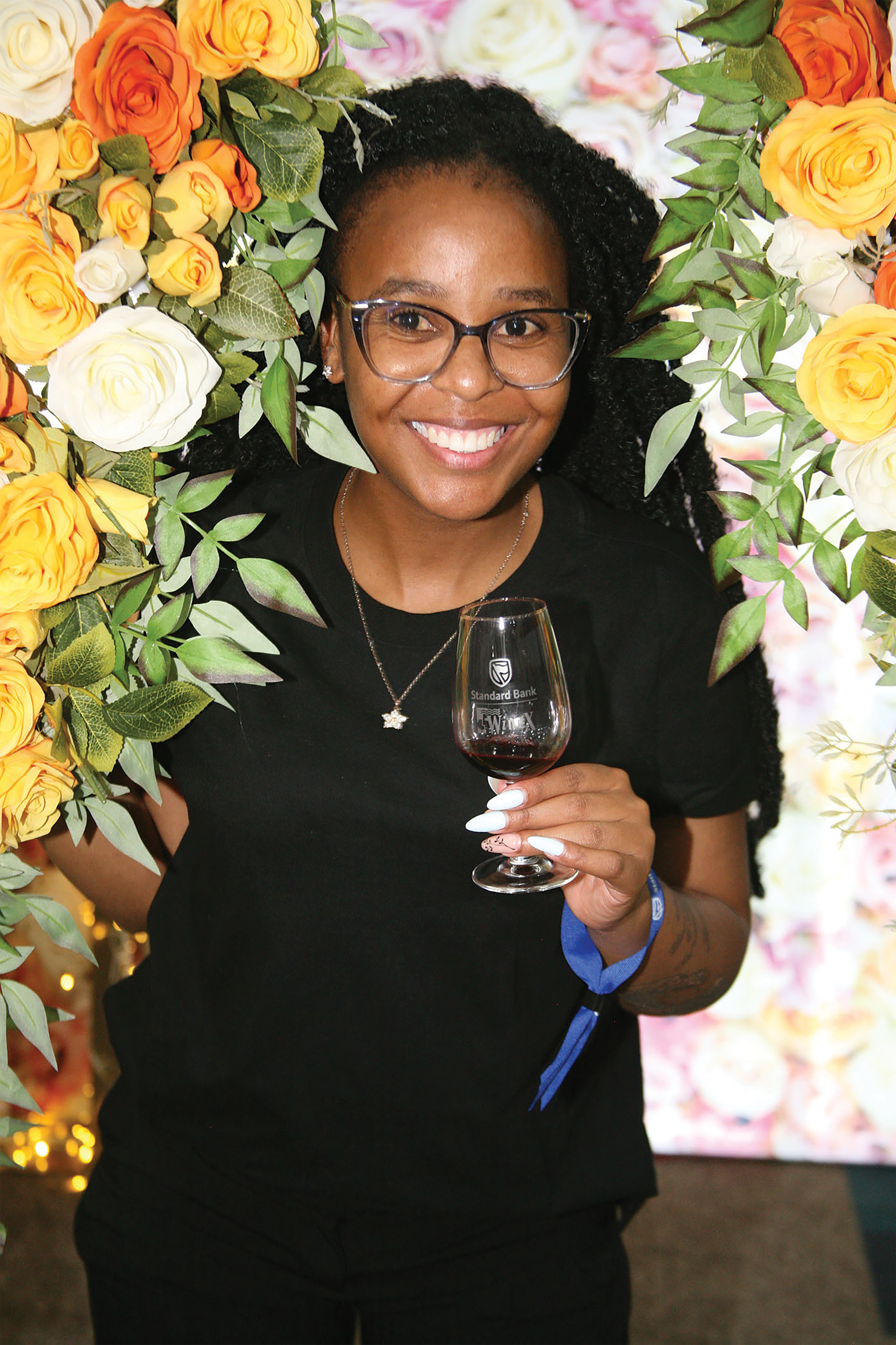 Flashing a smile at the Robertsons is Sharon Satekge at the opening night of the of Standard Bank WineX tasting where the best of the Cape comes to Jozi
