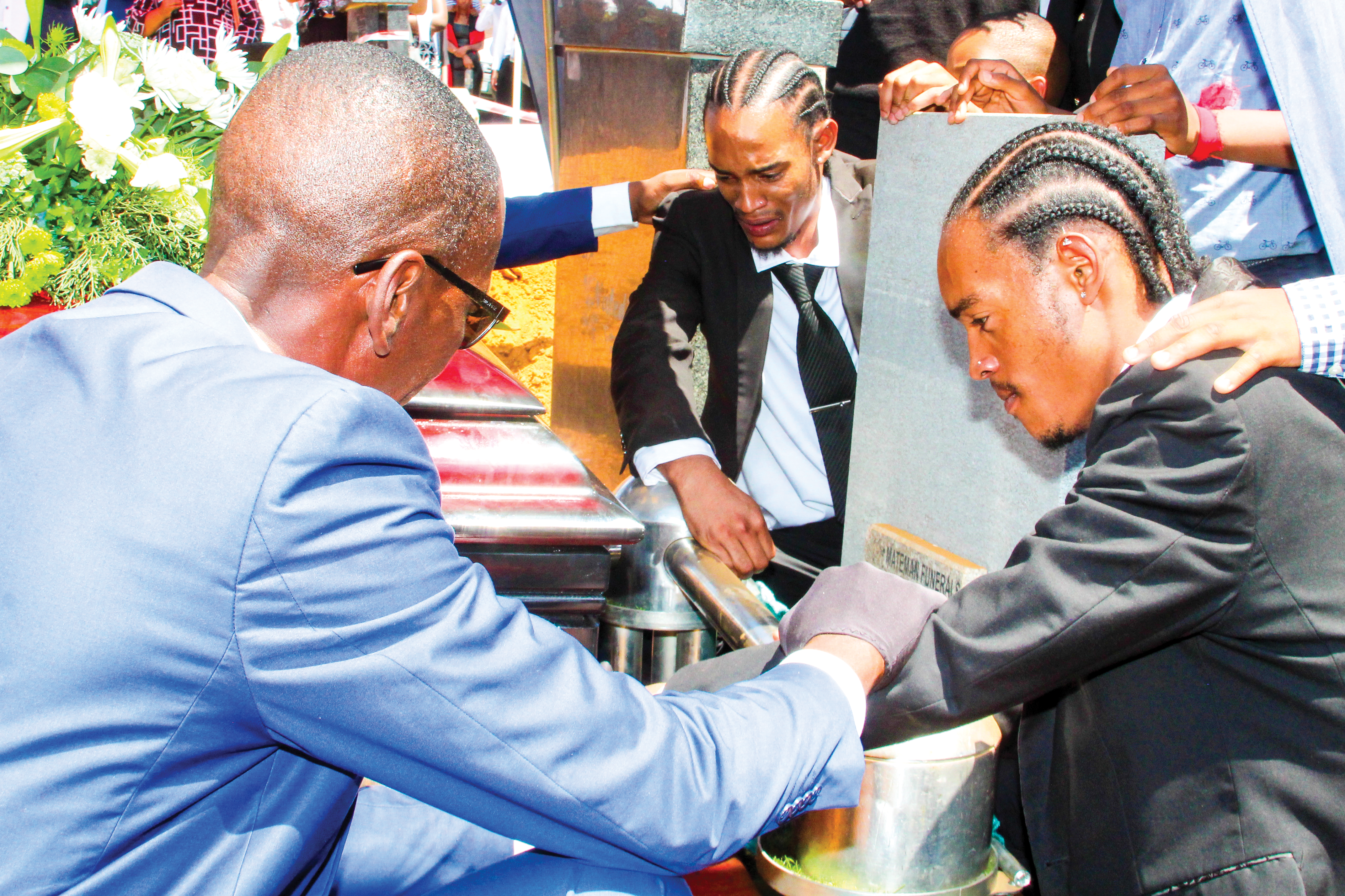 Tumelo and Itumeleng Khomane recorded being consoled gravesite at the Nasrec Memo- rial Park during the funeral of their father, ex-Bafana Bafana player, Papi Khomane.