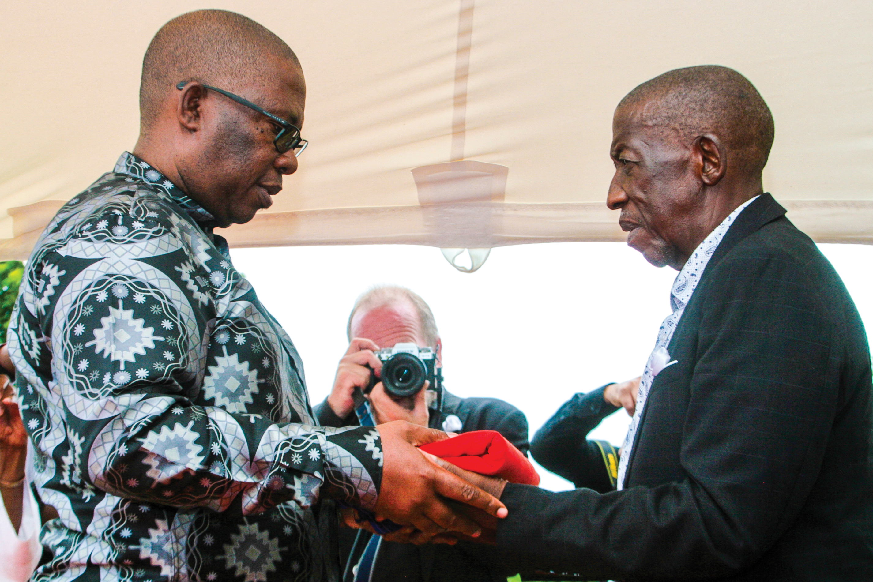 Premier Panyaza Lesufi handing over SA flag to Linda Magubane