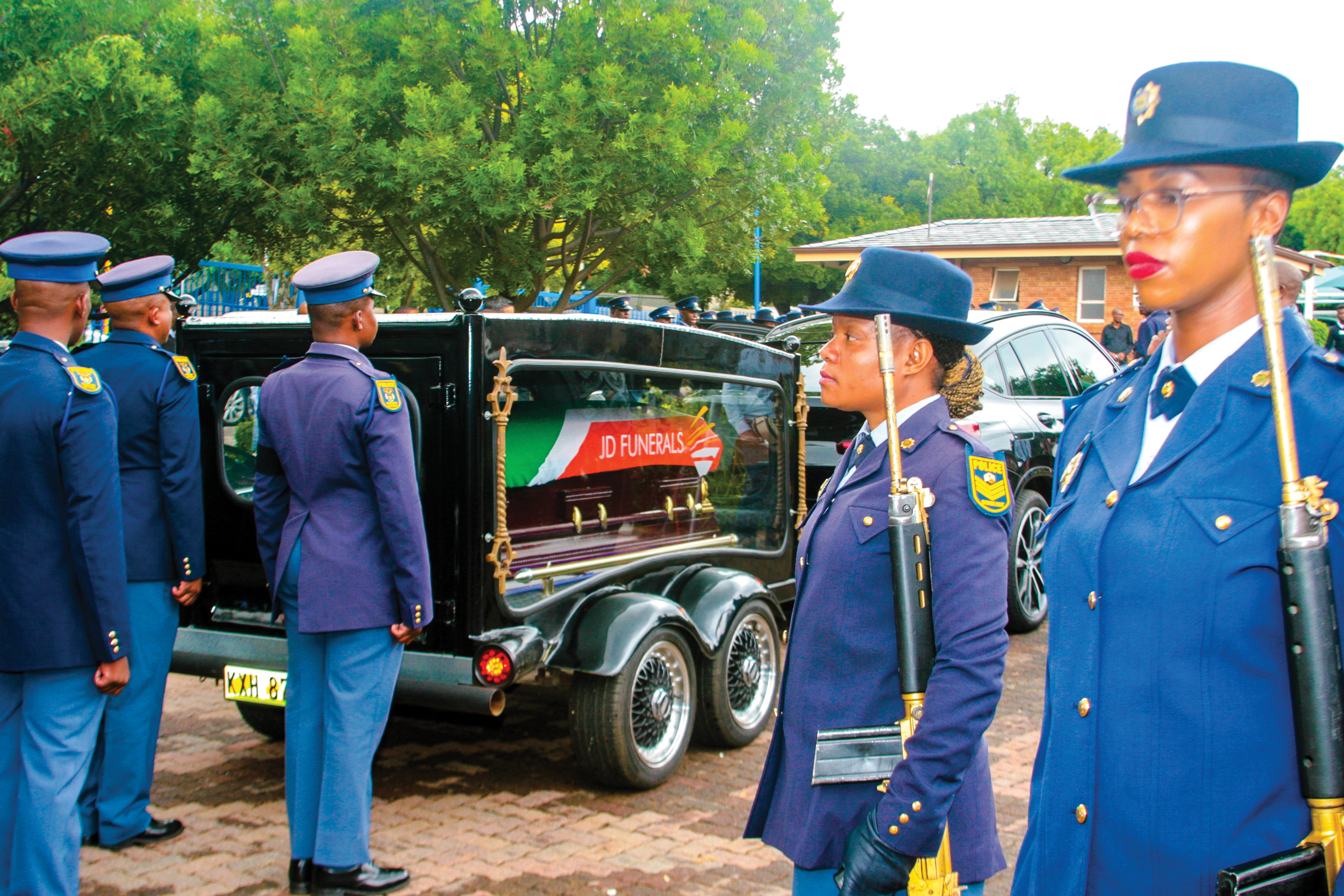 SAPS officers performing ceremonial honours during the funeral service of Peter Magubane