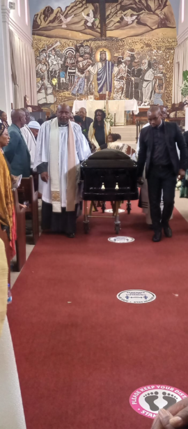 FAREWELL: A pastor at Christ the King church in Sophiatown, Johannesburg, leads a procession of pallbearers carrying Sedupe Ramakgopa’s coffin out of the parish to the cemetery yesterday.