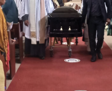 FAREWELL: A pastor at Christ the King church in Sophiatown, Johannesburg, leads a procession of pallbearers carrying Sedupe Ramakgopa’s coffin out of the parish to the cemetery yesterday.