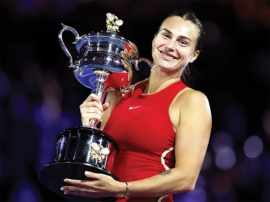 GOLDEN SMILE: Aryna Sabalenka savouring her moment of joy by lifting the Australian Open trophy she succesfully defended for a second time running on Saturday